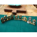 A small collection of miniature clocks, four marke