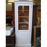 A modern white painted pine cupboard, with glazed