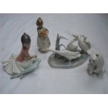 Four Lladro figures, a polar bear, a group of ducks, a girl carrying oranges and a ballerina.