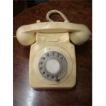 A cream 746 model telephone.