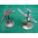 Two brass metal desk ornaments, on in the form of a Spitfire, the other a Concorde.