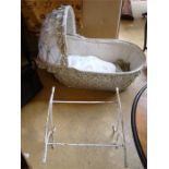 A vintage childs cot with iron rocker.