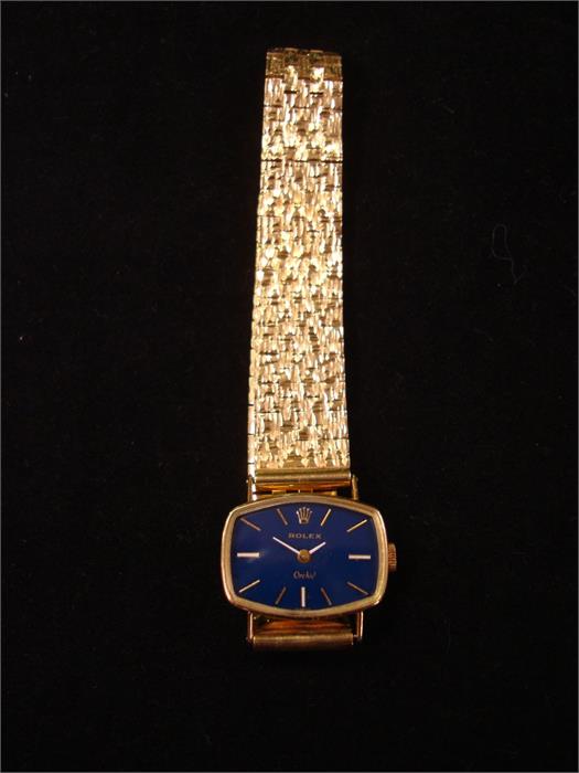 An 18ct gold ladies Rolex Orchid wristwatch, case measuring approx 23.3mm x 17.4mm, blue dial with