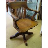 A wooden saddle seat office chair.