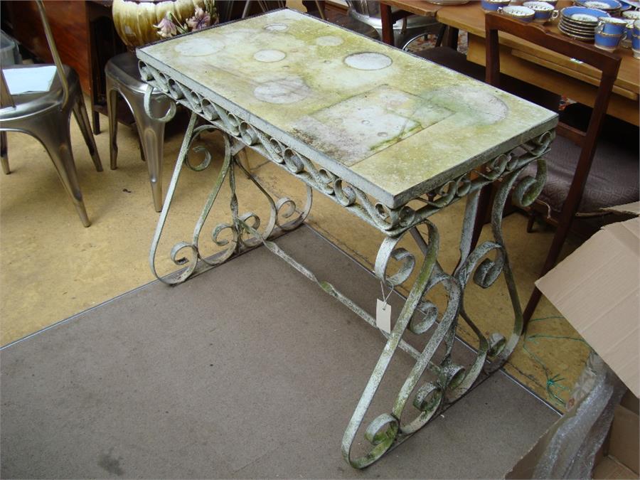 A marble topped garden table, on cast iron base.