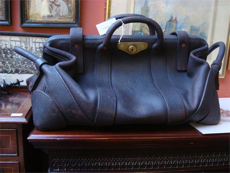 A vintage brown leather bank bag with carrying handles, inscription on Hobbs & Co lock L.C.W & P