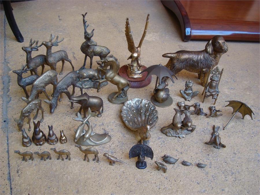 A selection of brass animal ornaments including frogs, birds, deer etc.