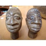 Two African influenced carved stone heads.