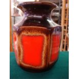 A Scheurich Keramik West German art pottery vase, decorated in red on a brown ground, hexagonal body