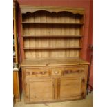 A pine dresser with plate rack.