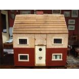 A scratch built dolls house, opening front and rear to reveal two floors, partially furnished.