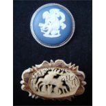 A silver mounted Wedgwood Jasperware brooch together with a carved bone Austrian brooch depicting