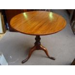 A pedestal tripod occasional table.