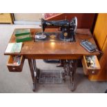 A vintage Singer Sewing machine, on cast iron treadle base with SInger B.A.K electric motor, foot