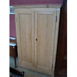 A pine double door wardrobe.