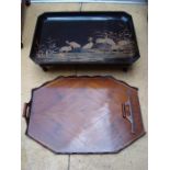 An Oriental style decorated tray on legs together with another tray.