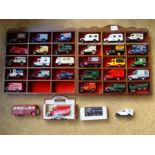 A collection of Lledo Days Gone cars in display cases (29) together with a Hornby battery powered