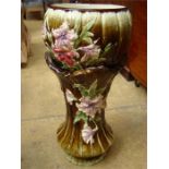 A Majolica style glazed jardiniere and stand with a pink orchard design on green background, a/f.