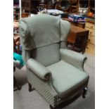 A modern upholstered wing armchair.