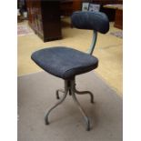 A vintage office swivel chair, with adjustable pad