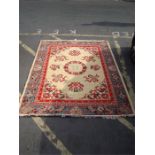 A Chinese syle rug, cream ground with floral borde