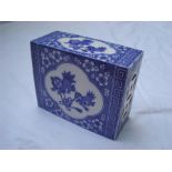 A Chinese blue and white incense / opium pillow. 14.5cm wide x 6.5cm deep x 12cm high.