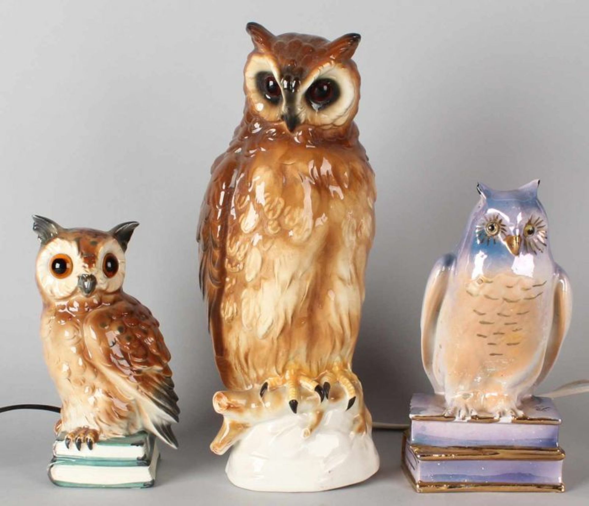 Three antique porcelain owls as smoke repellents. (First half 20th century). Dim. 21-35 cm.