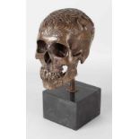 Bronze carved skull on black marble base, 21st Century. Indian carvings. Dim. 39 cm. In good