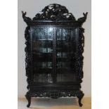 Antique Chinese richly stitched porcelain wardrobe with dragons on the lights, and fish and crown.