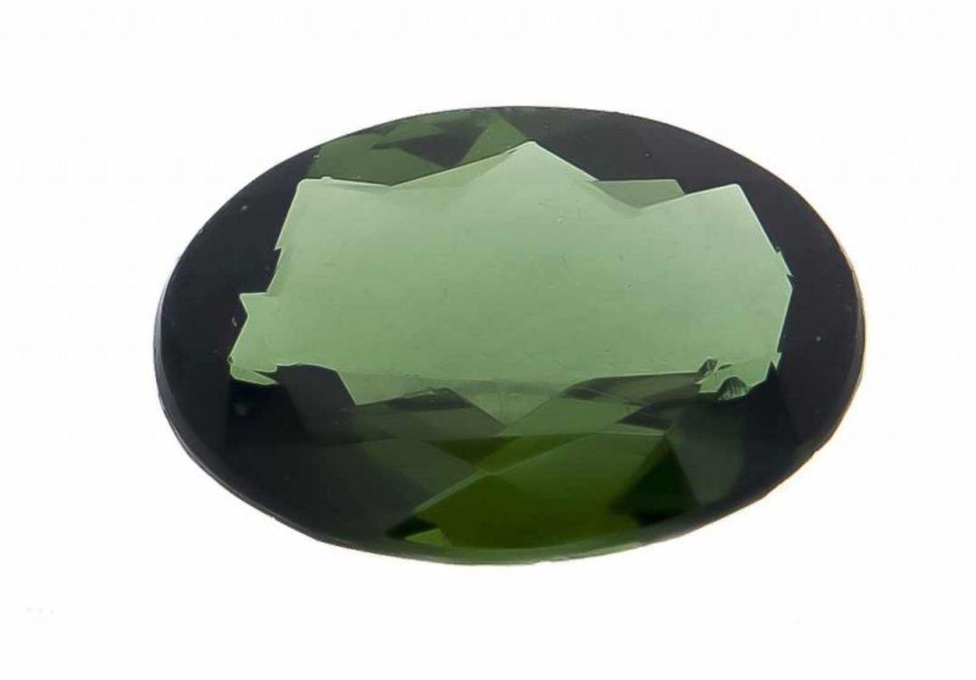 Oval shredded tourmaline, 4.62 ct. Stone is intensely green in color. Dimensions: 13.87 x 9.83 x 4.