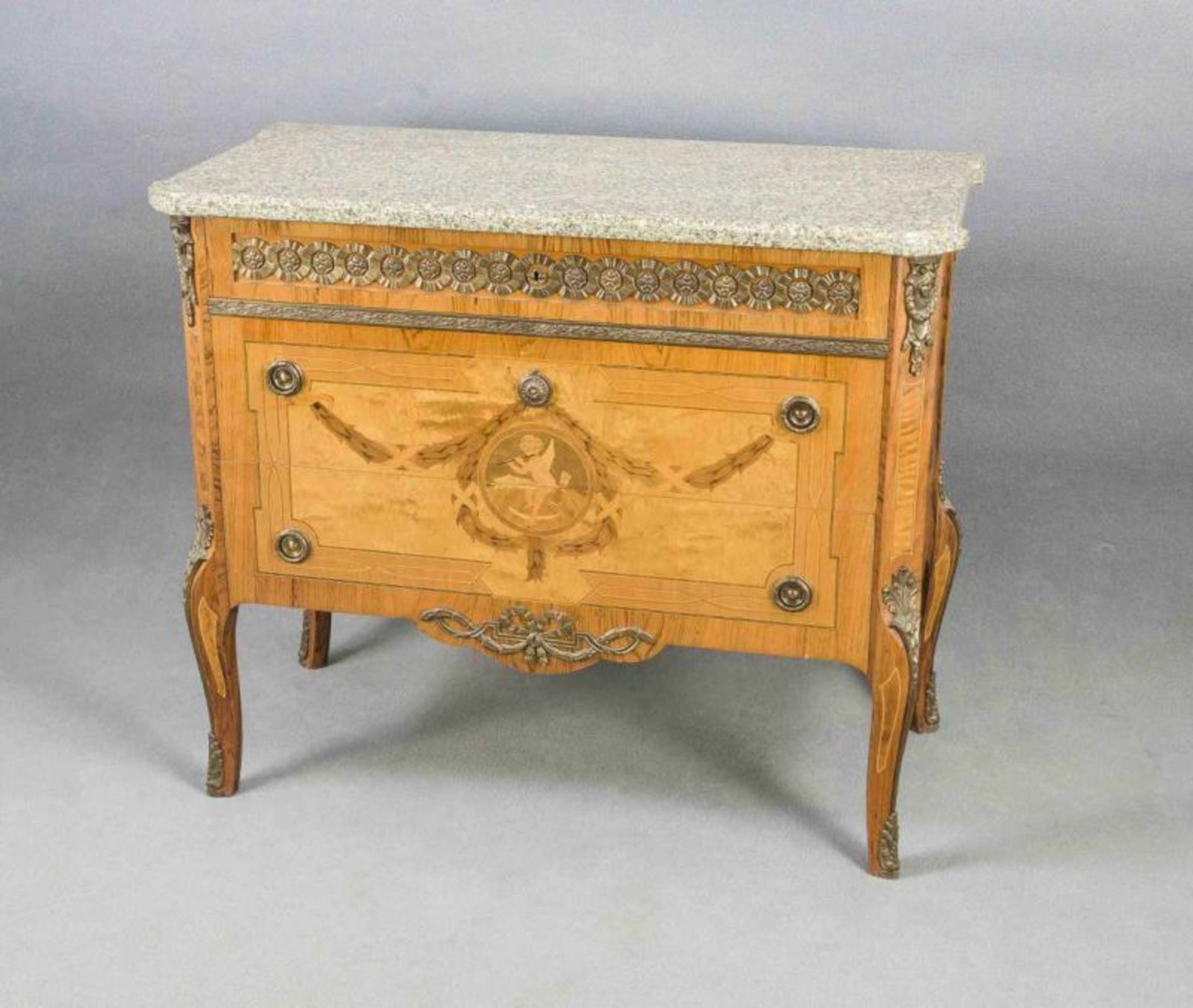 French style chest of drawers with inlaid marble leaf and bronze batter. Glued with various woods.