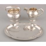 Silver cream set on leaf, 835/000. A milk can and sugar bowl: model pearl with spherical profile,