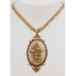 Yellow gold necklace, 585/000 with pendant, 375/000, with moonstone-like stone.  Ornate flat cord