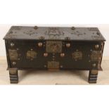 Ancient Indonesian chest with rich copper fittings. Coffin has animal shows and copper bulbs (