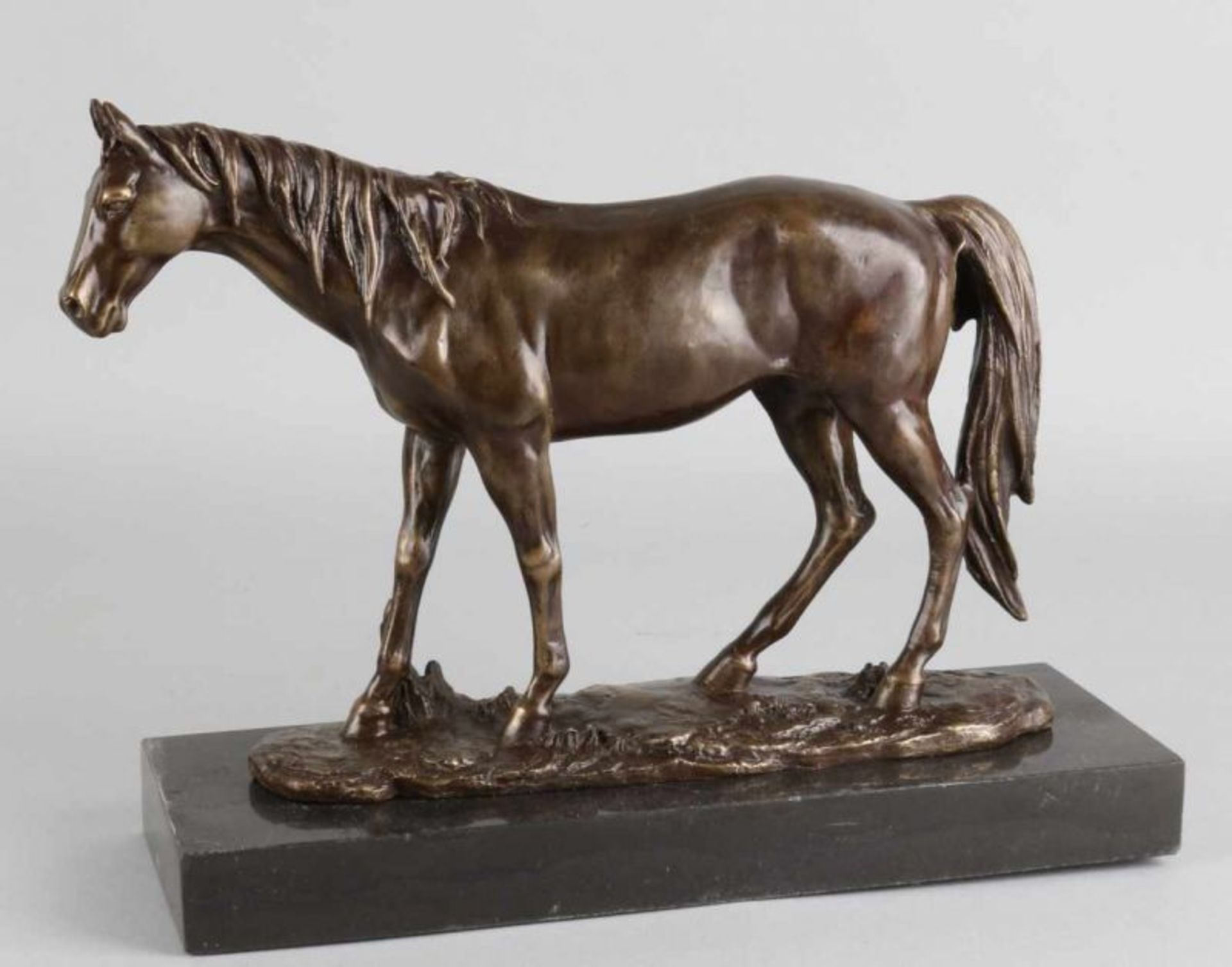 Bronze horse on black marble basement. 21st century. Dimensions: 24 cm. In good condition.