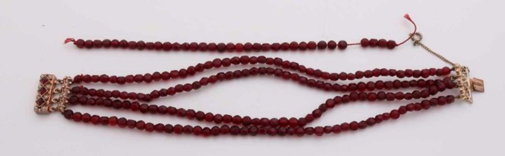 Garnet bracelet with gold closure, 585/000. Bracelet with 4 rows of gated pearls, ø 4 mm., Attached