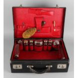 Antique leather toilet case with accessories + vials fitted with nickel plated caps. About 1915.