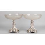 Two crystal tableware placed on a silver foot. Round crystal bowl, with matted bottom and a