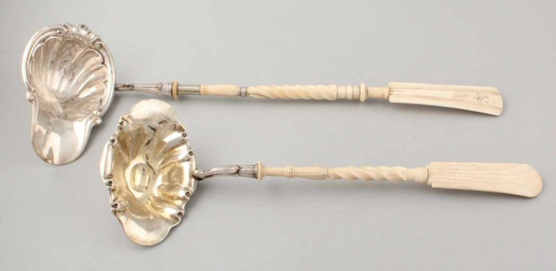 Two serving spoons, one silver with bush-shaped contoured bowl and ivory machined steel, 35x12 cm,