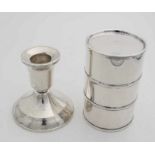 A candlestick, silver filled, round model with filet edge, ø 7x8cm, engraved. And a cylindrical