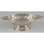 Ancient silver brandy bowl, driven and chiselled with C-volutes, flowers and a flower basket, with