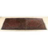Old Persian runner. Nice hand-knotted dark earth shades. Dimensions: 205 x 76 cm. In good