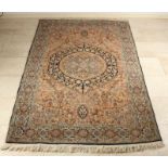 Old Persian garment. Finely knotted. Light blue with floral decors etc. Size: 140 x 200 cm. In good
