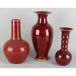 Three old Chinese porcelain vases with red icing. 20th century. One vase is labeled. Dimension: