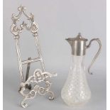 Old plated easel and glass carafe with plated frame. 20th century. Dimensions: 30 - 41 cm. In good