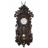 Austrian wall clock with carved case Austria-Hungary, late 19th century, carved wooden case with a