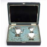 A four piece Japanese silver tea set. Hallmarked. In its original case, with a silk label: G. Ikoma