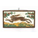 De Porceleyne Fles Delft A cloisonné ceramic tile depicting a running hare, designed by L.E.F.