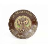 Nieuwe Kunst A ceramic wall plate with applied text 'De morgenstond heeft goud in den mond',