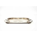 Argentor-Werke, Rust & Hetzel, Wien A silvered metal serving dish with two grips, with clear cut